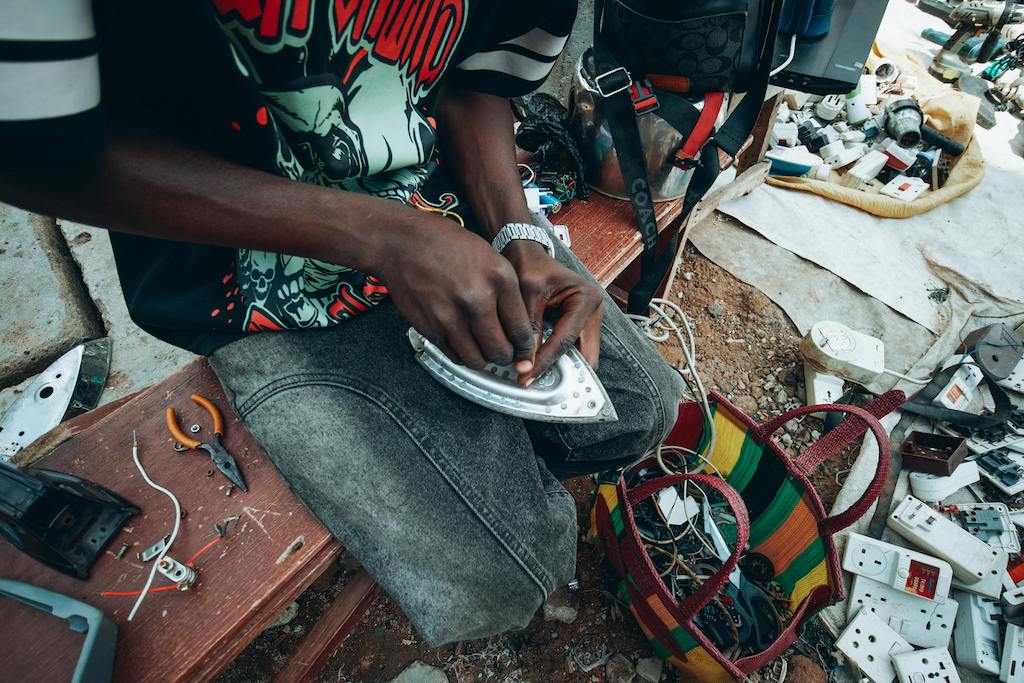 A local technician working on electrical repairs in Nigeria, representing small business owners registering with the CAC.